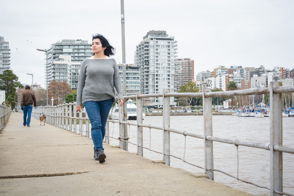 young latina tourist walking on the pier over the 2023 11 27 05 00 55 utc